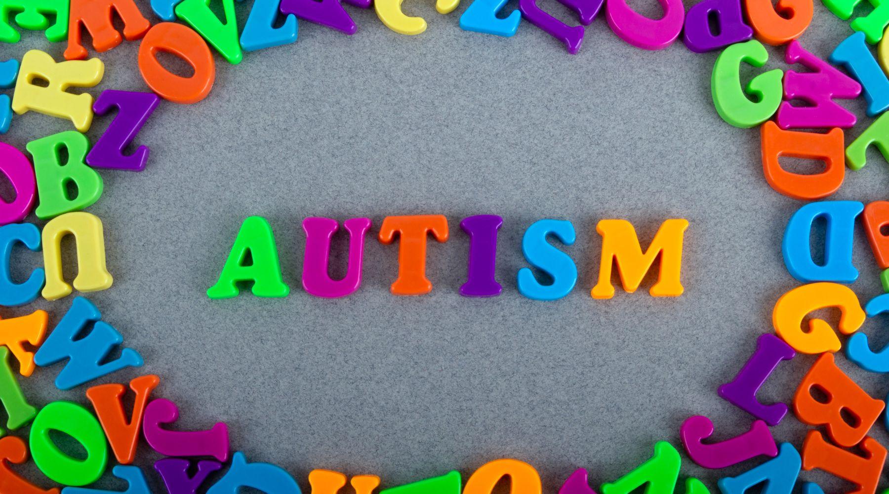 colorful plastic letters reading autism - Sticky Balls Boutique