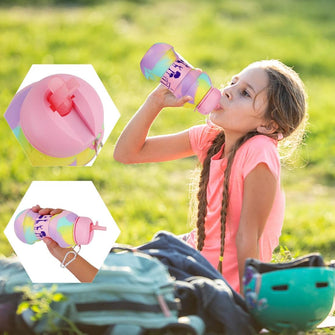 young girl sitting on the grass drinking in a pink unicorn Pink unicorn with key chain Foldable Kids Water Bottle - Sticky Balls Boutique